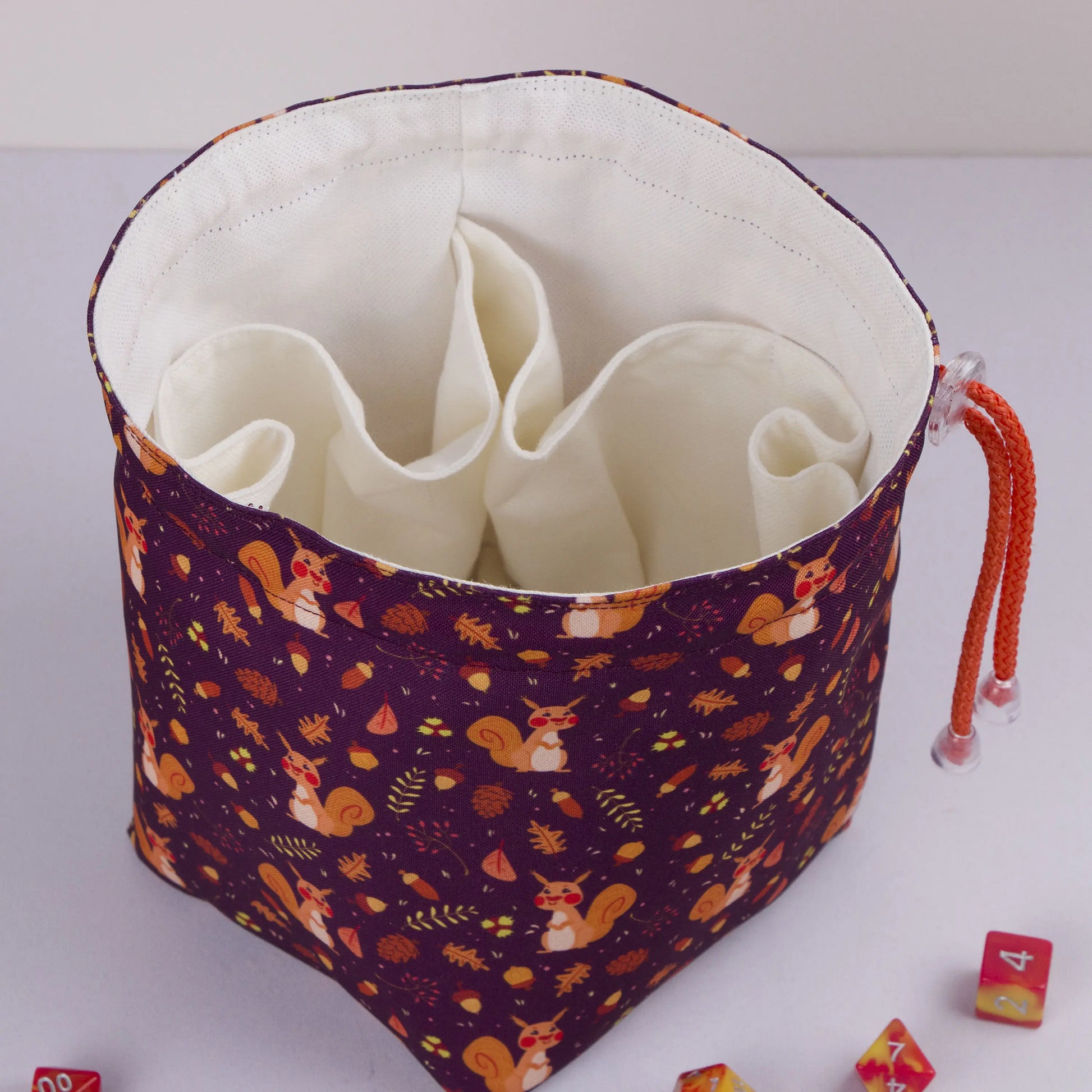 Open squirrel dice bag showing the soft cotton lining that protects dice.
