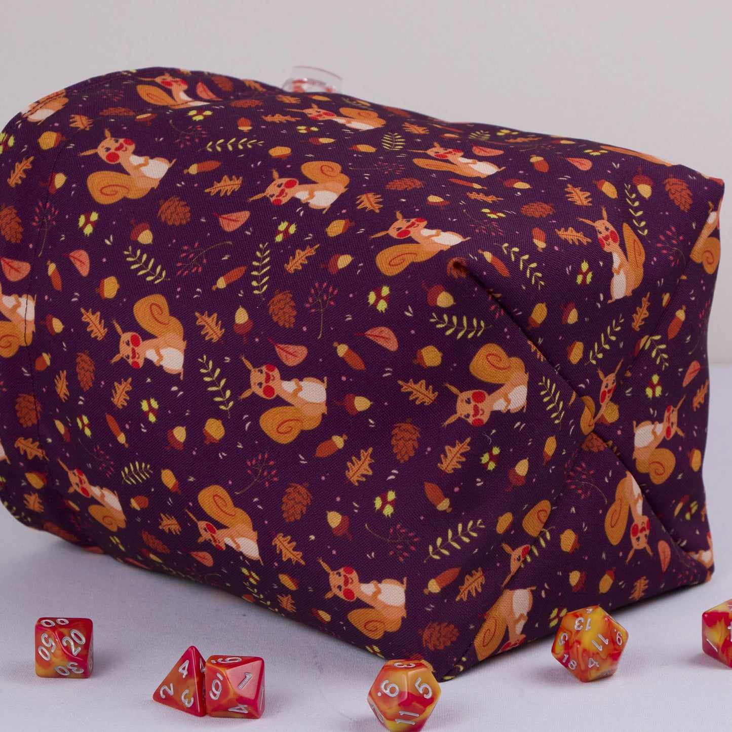Squirrel dice bag with orange drawstring closure — cute cottagecore DnD pouch.