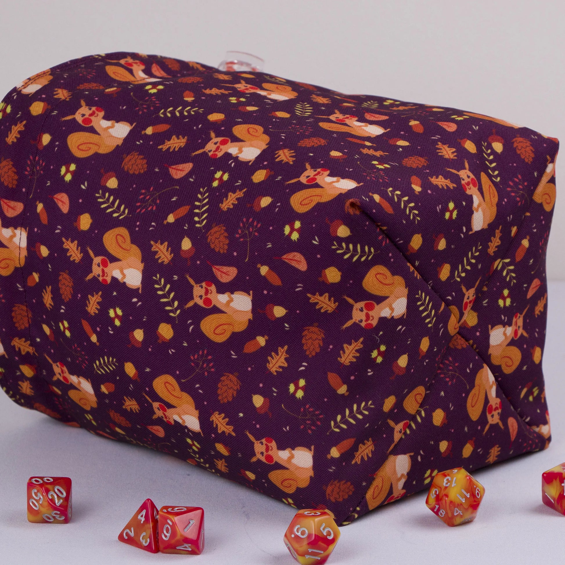 Squirrel dice bag with orange drawstring closure — cute cottagecore DnD pouch.