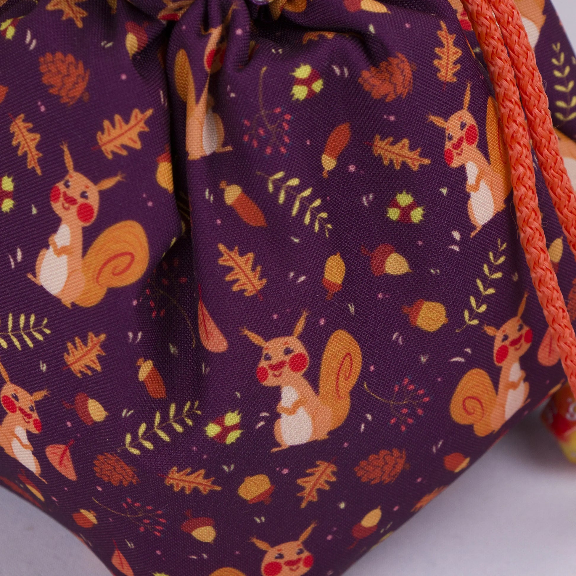 Squirrel dice bag standing upright on its square base for table-side access.