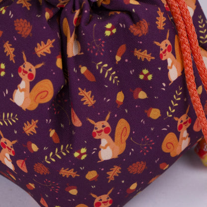 Squirrel dice bag standing upright on its square base for table-side access.