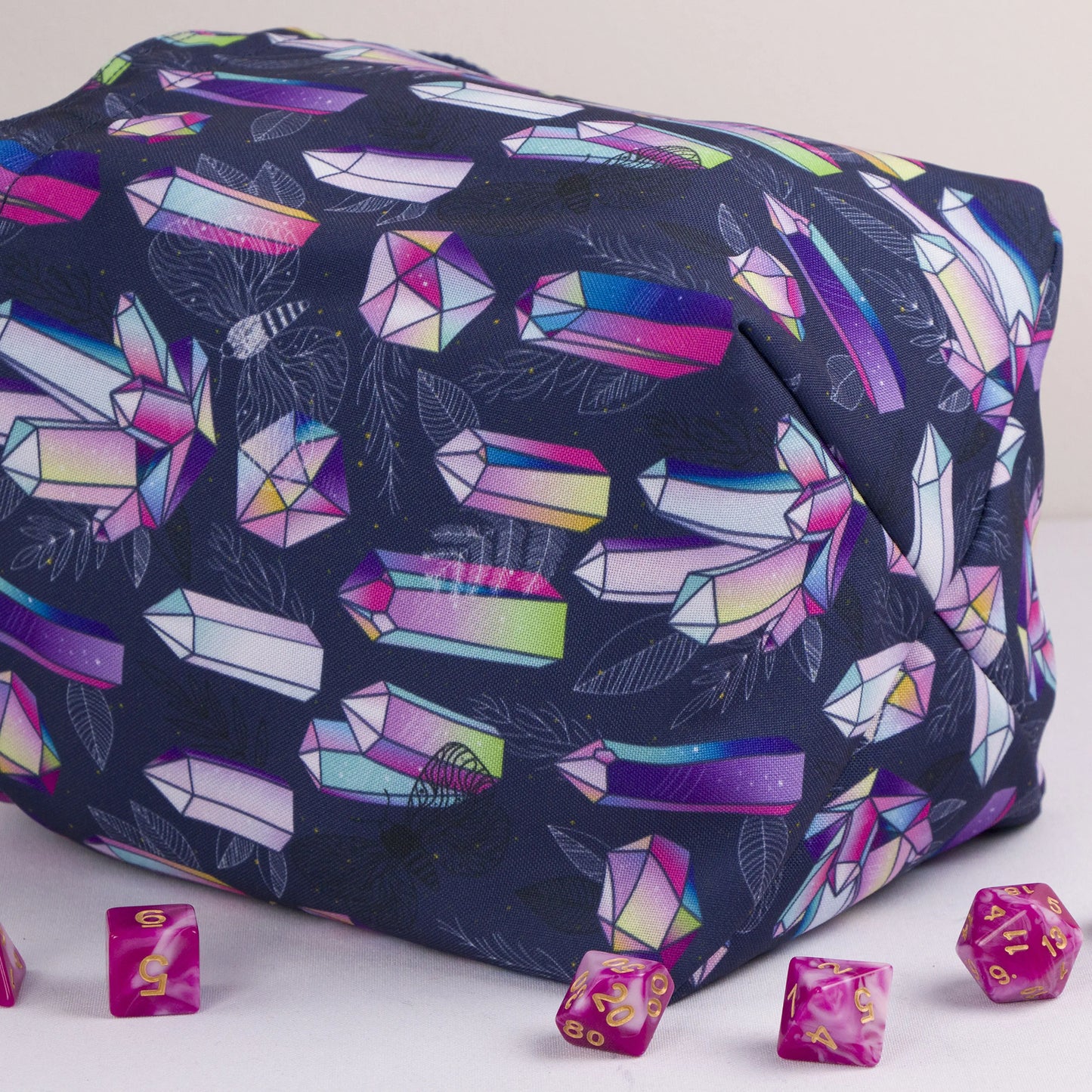 Rainbow crystal dice bag standing upright on its square base — witchy DnD pouch.