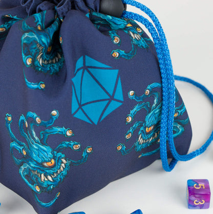 Beholder dice bag front view — teal beholders with eyestalks on navy fabric, blue drawstring.