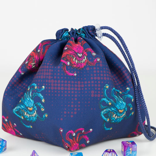 Dice Bag beholder — handmade monster-themed dice pouch, perfect for dungeons and dragons gifts or as a practical rpg dice bag. Crafted with durable gabardine exterior and soft 100% cotton lining, this bag is available as a classic pouch or 6-pocket organizer for dice sets. Freestanding design with 5" square base and 7" height, secure drawstring closure with plastic clip. Ideal for dice storage, tokens, and RPG accessories. Gift-ready, eco-friendly, and handmade with love.