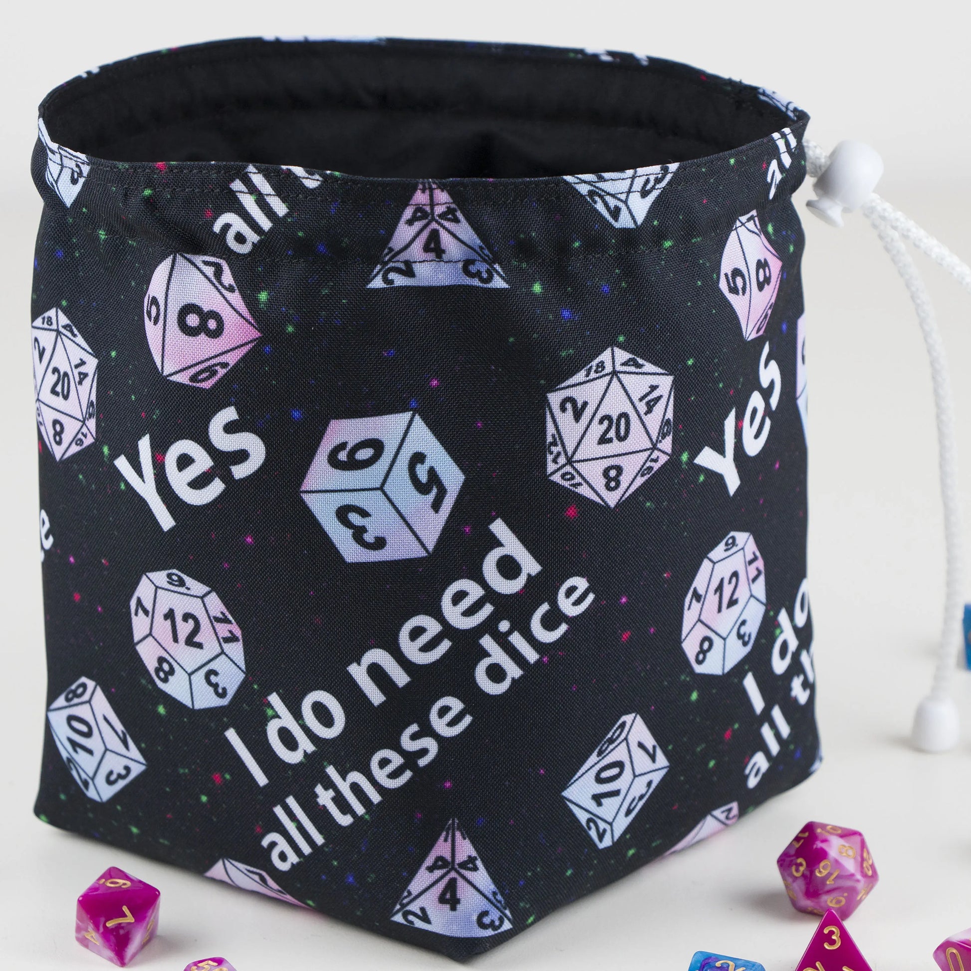 A funny DnD birthday gift — 'Yes I do need all these dice' print with pastel dice on starry black, holds 300+ dice.