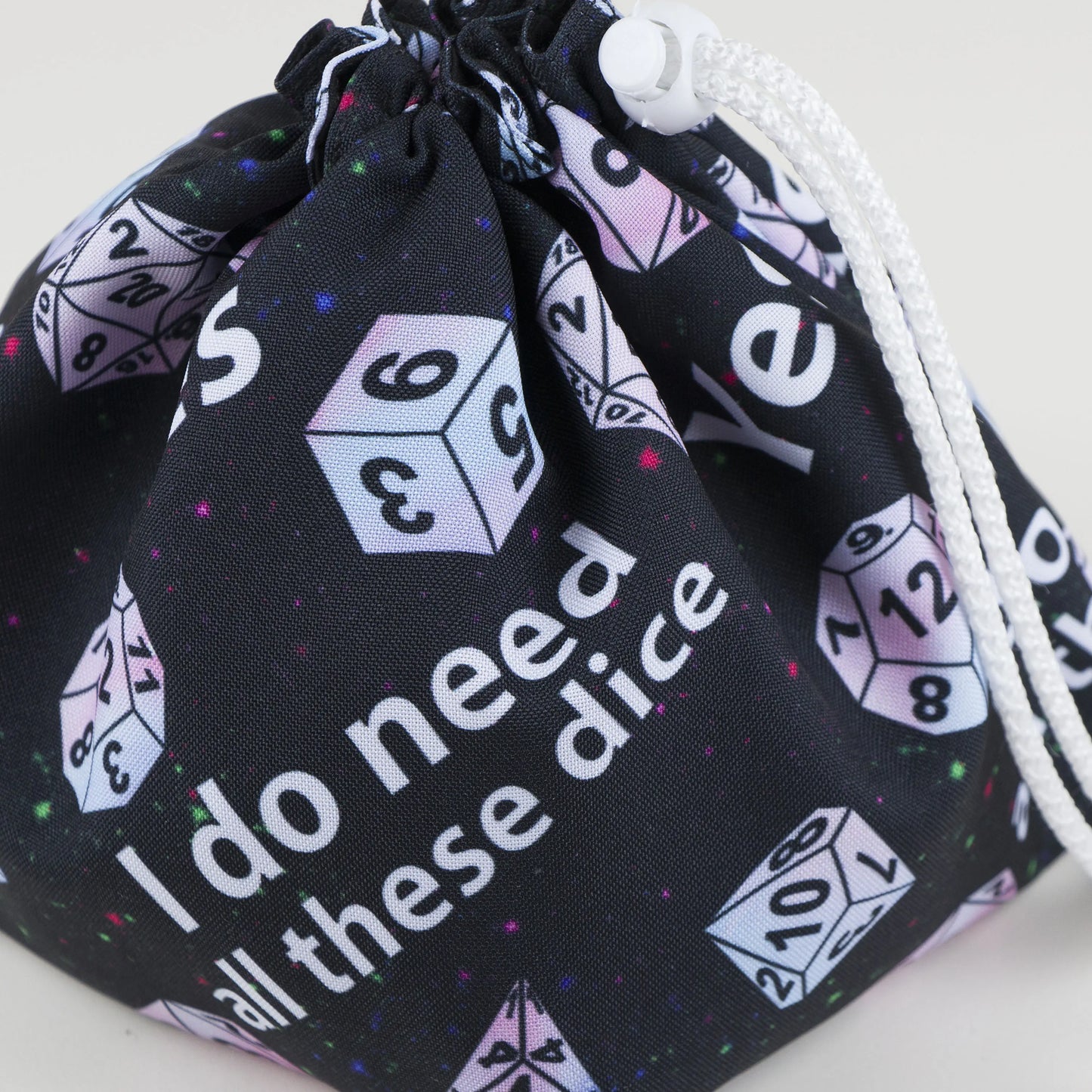 Detail of the 'I do need all these dice' slogan and pastel dice on the bag — handmade gabardine.