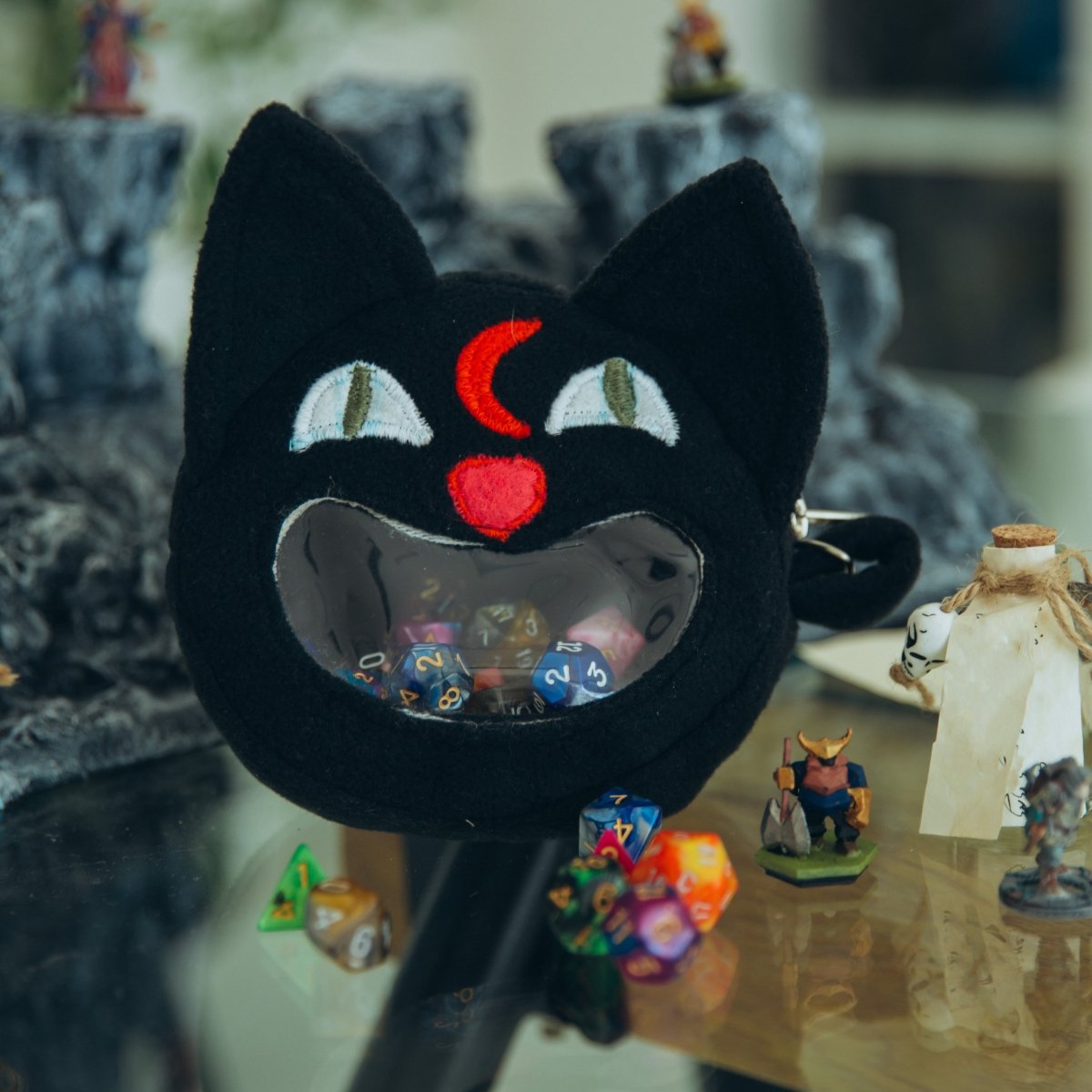 Cat ita bag — ita bag with a dice bag charm clip for convention display.