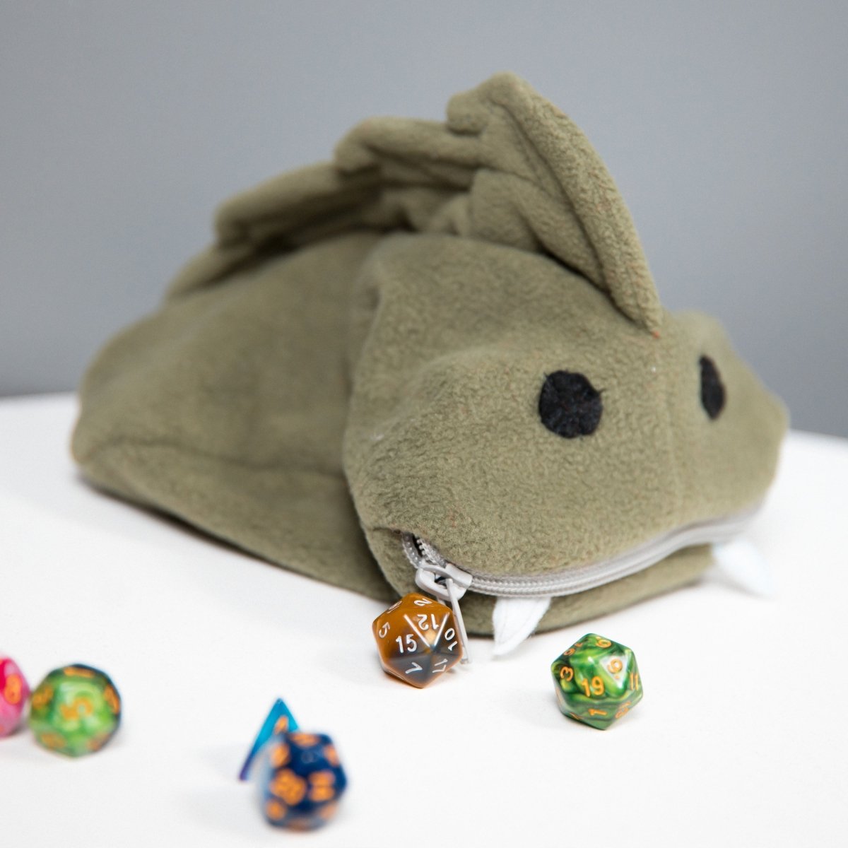 Cute green fish monster plush dice bag — cute creature plush dice bag that doubles as display art.