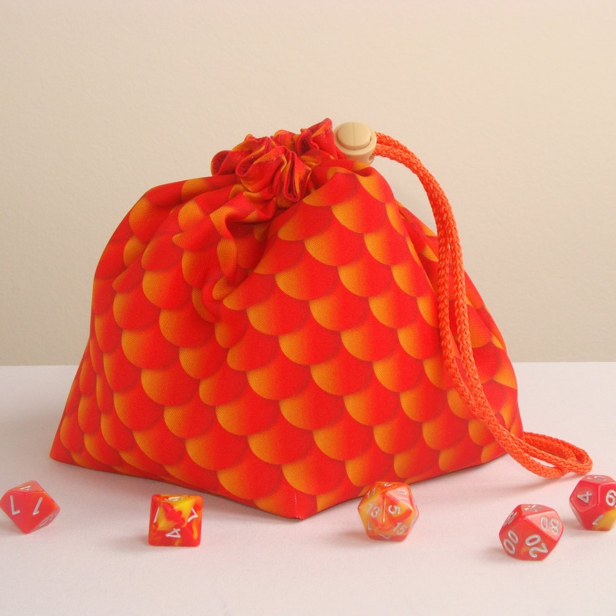 Dragon scale dice bag with pockets — handmade gabardine DnD organizer holding 300+ dice across 6 pockets.