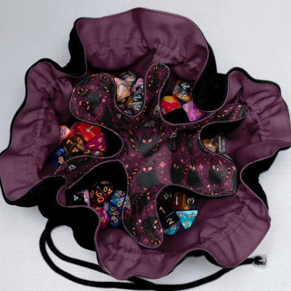 Mothman dice bag with compartments open — showing 6 internal pockets with dice sets